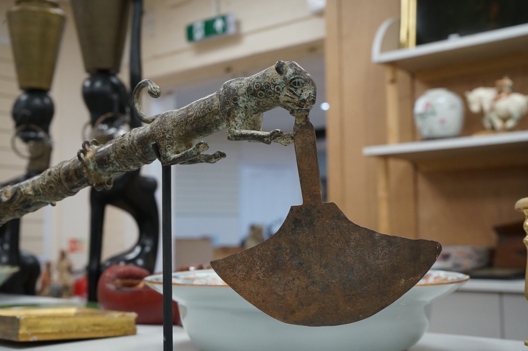 A Benin-type bronze zoomorphic ceremonial axe, on stand, 62cm long